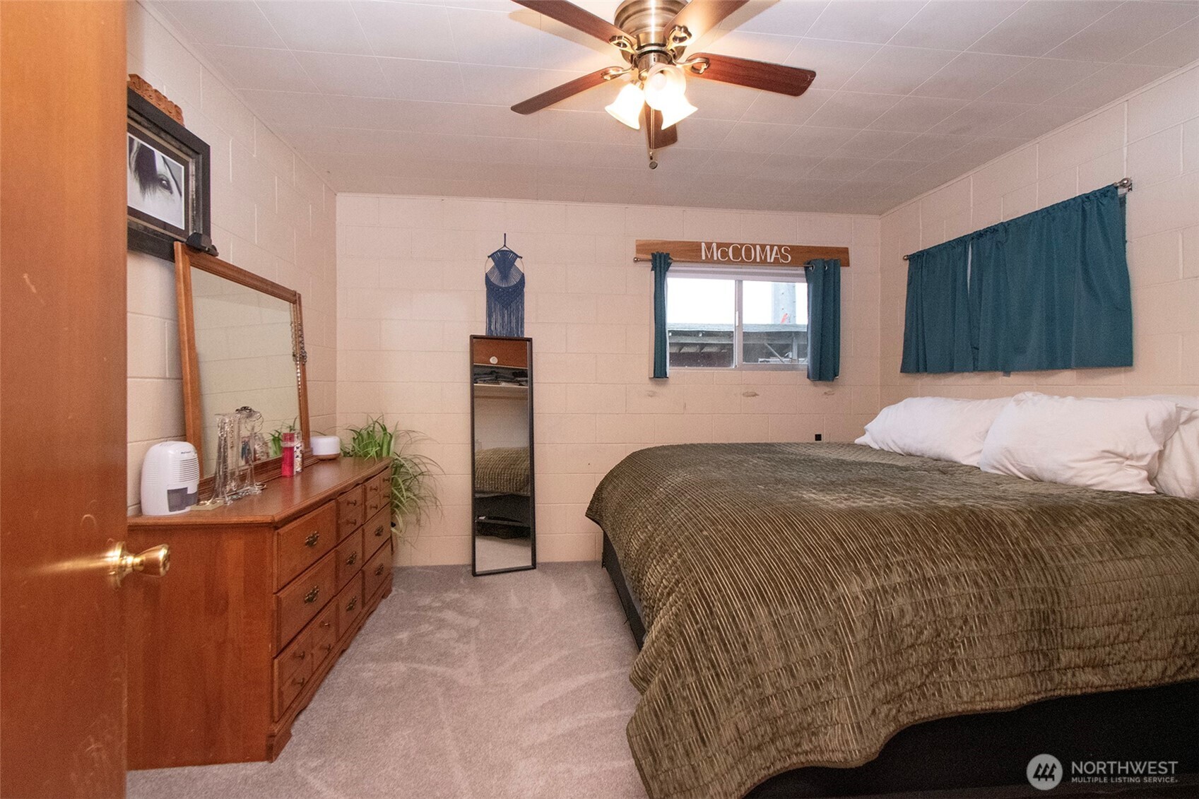 163 Cliff Robinson Lane Sequim, WA 98382 - Photo 21 of 40 a bedroom with a bed and a chandelier