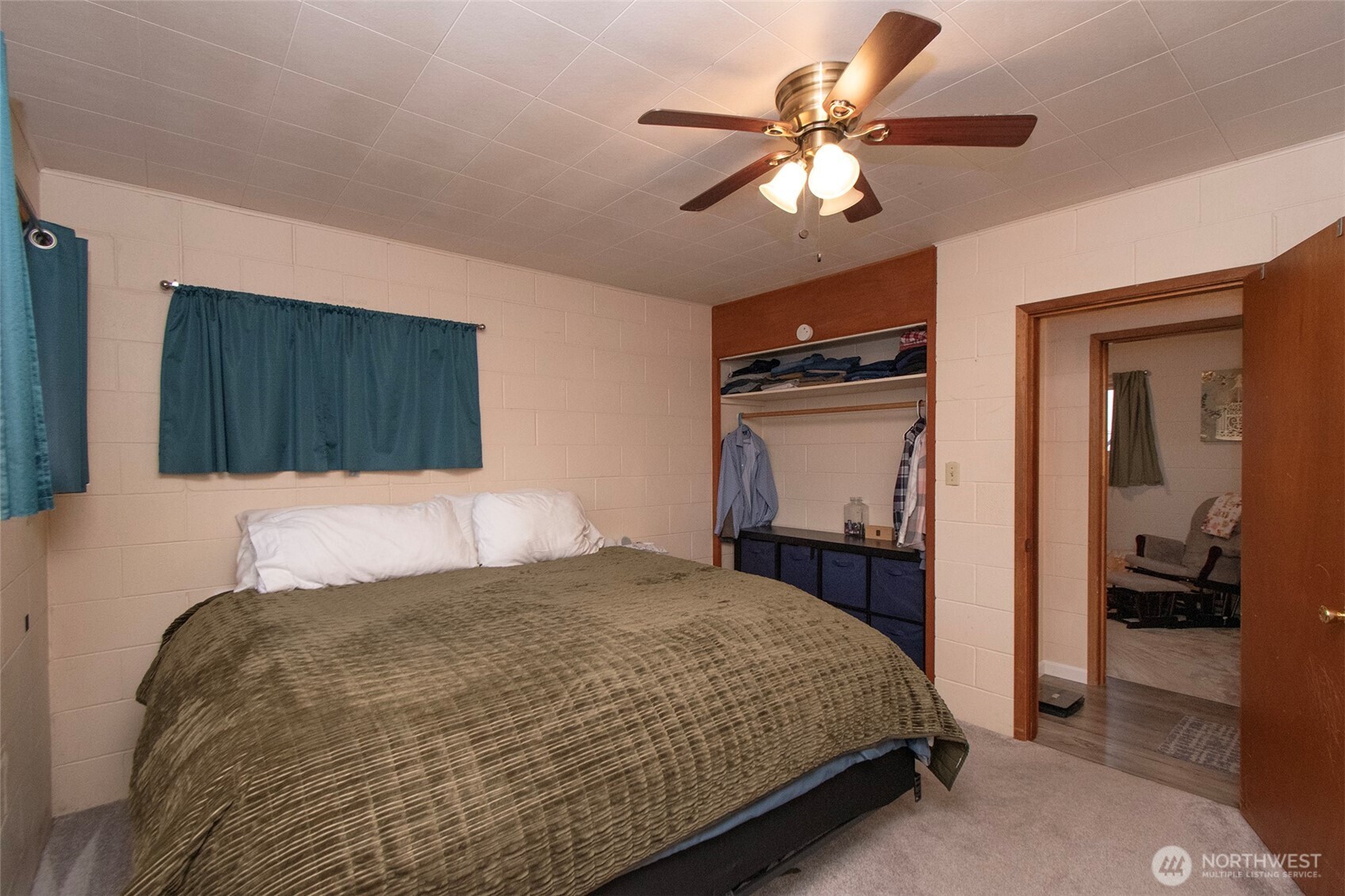 163 Cliff Robinson Lane Sequim, WA 98382 - Photo 22 of 40 a bedroom with a bed and a chandelier