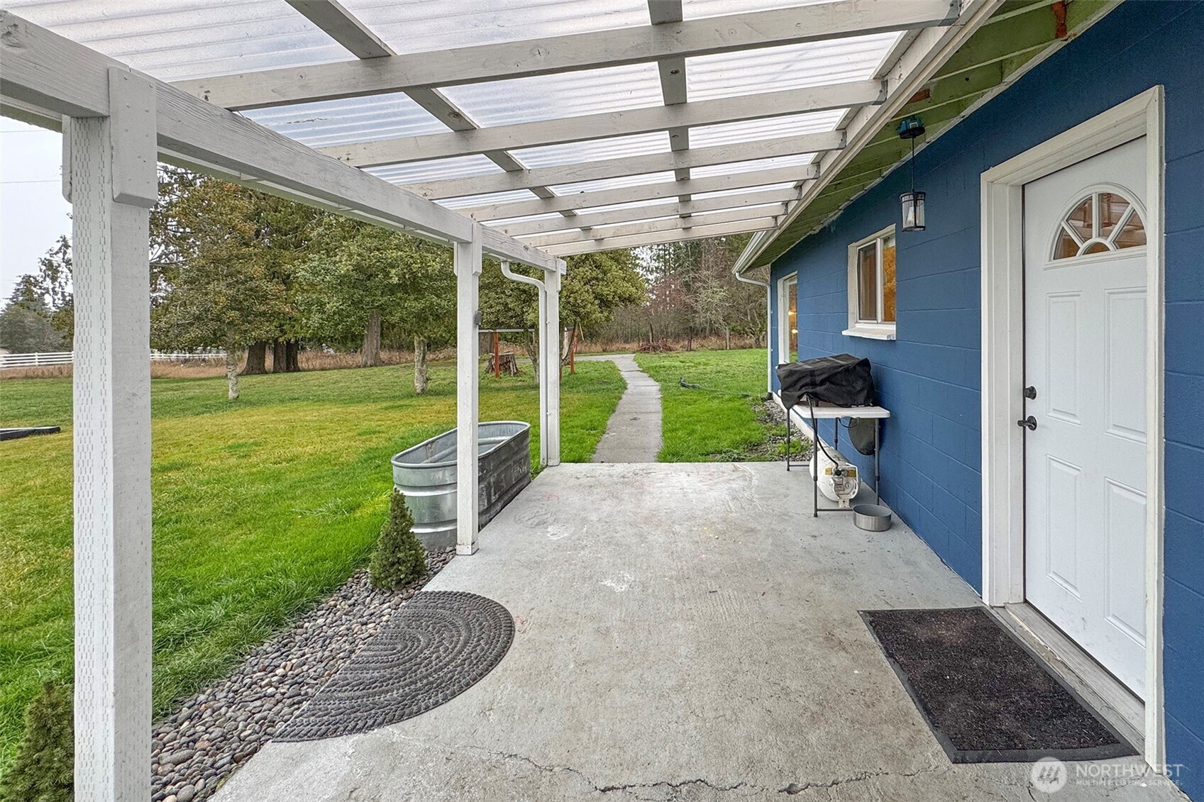 163 Cliff Robinson Lane Sequim, WA 98382 - Photo 5 of 40 a view of a porch with furniture and a yard