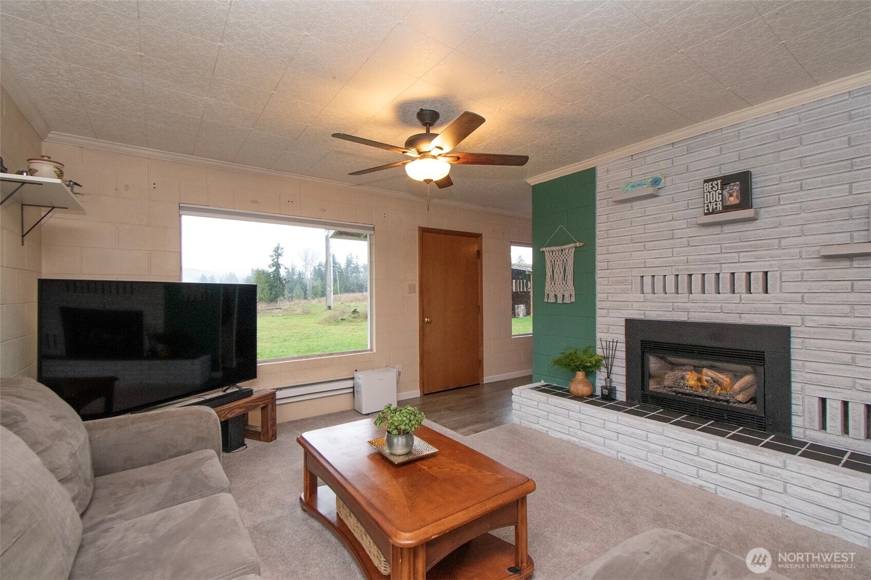 163 Cliff Robinson Lane Sequim, WA 98382 - Photo 7 of 40 a living room with furniture a flat screen tv and a fireplace