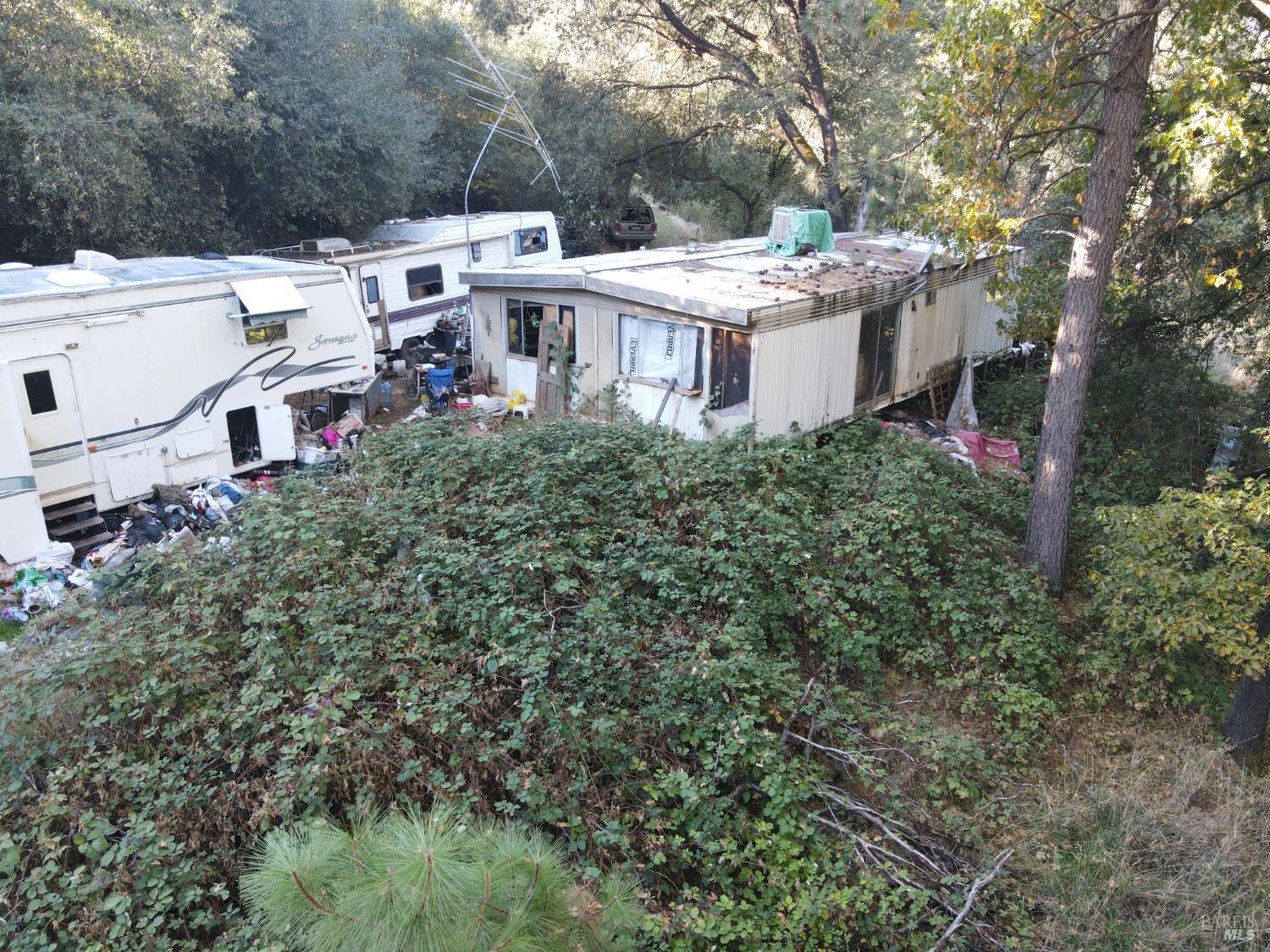 22666 Quail Mine Road Sonora, CA 95370 - Photo 7 of 10 a view of a white house with a yard and sitting area