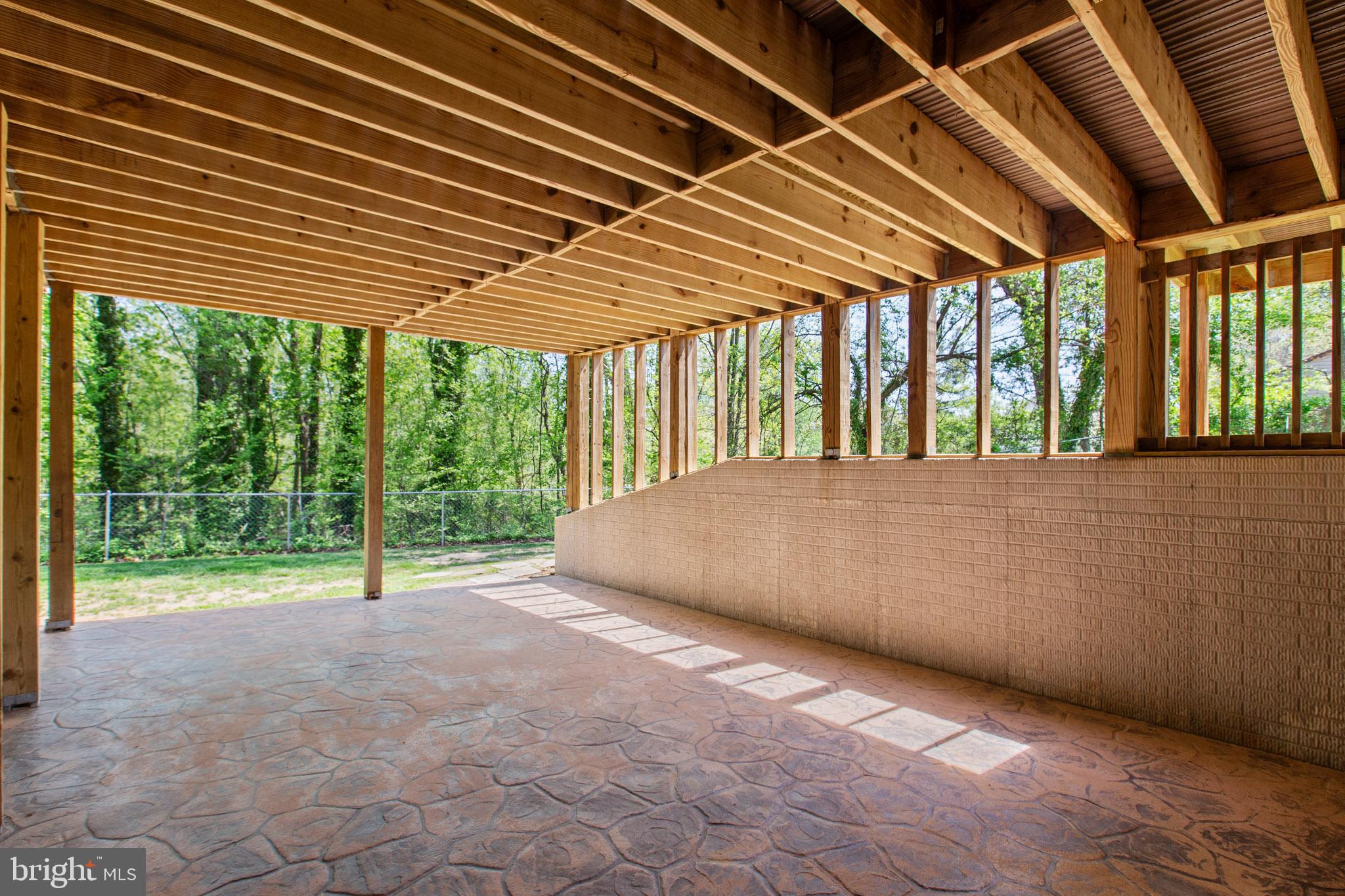 24524 Ruff Ruff Lane Hollywood, MD 20636 - Photo 35 of 41 Downstairs Stamped Concrete Patio under deck