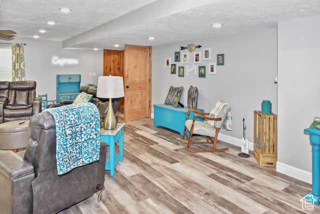 1500 Fish Creek Road Bancroft, ID 83217 - Photo 26 of 45 Living room featuring a textured ceiling, wood finished floors, and recessed lighting
