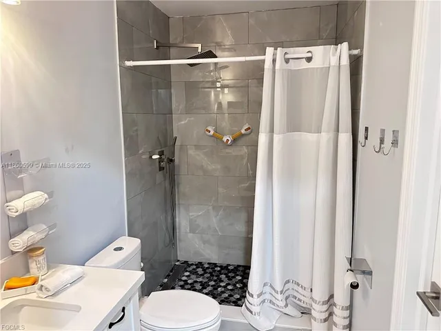 a bathroom with a toilet and a shower