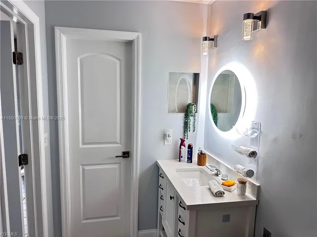 a bathroom with a sink vanity and mirror