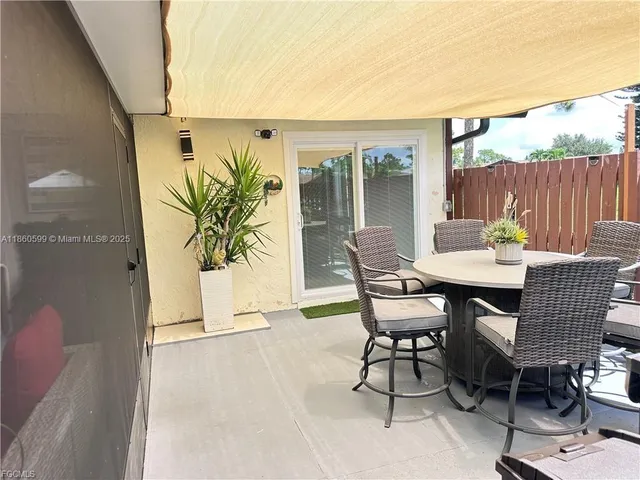a view of a patio with table and chairs and potted plants