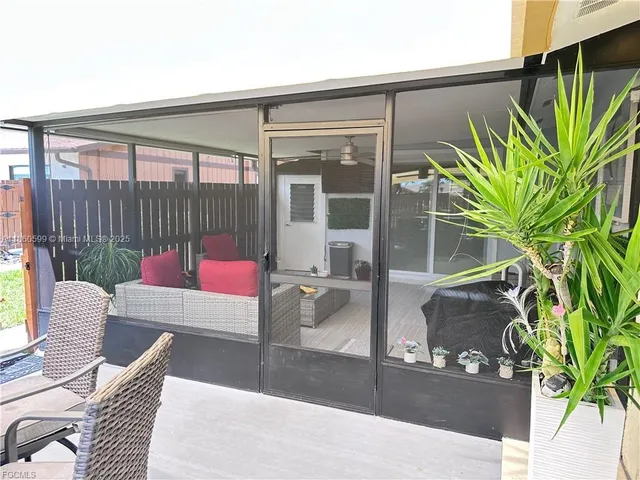 a view of a patio with couches and a potted plant on a table