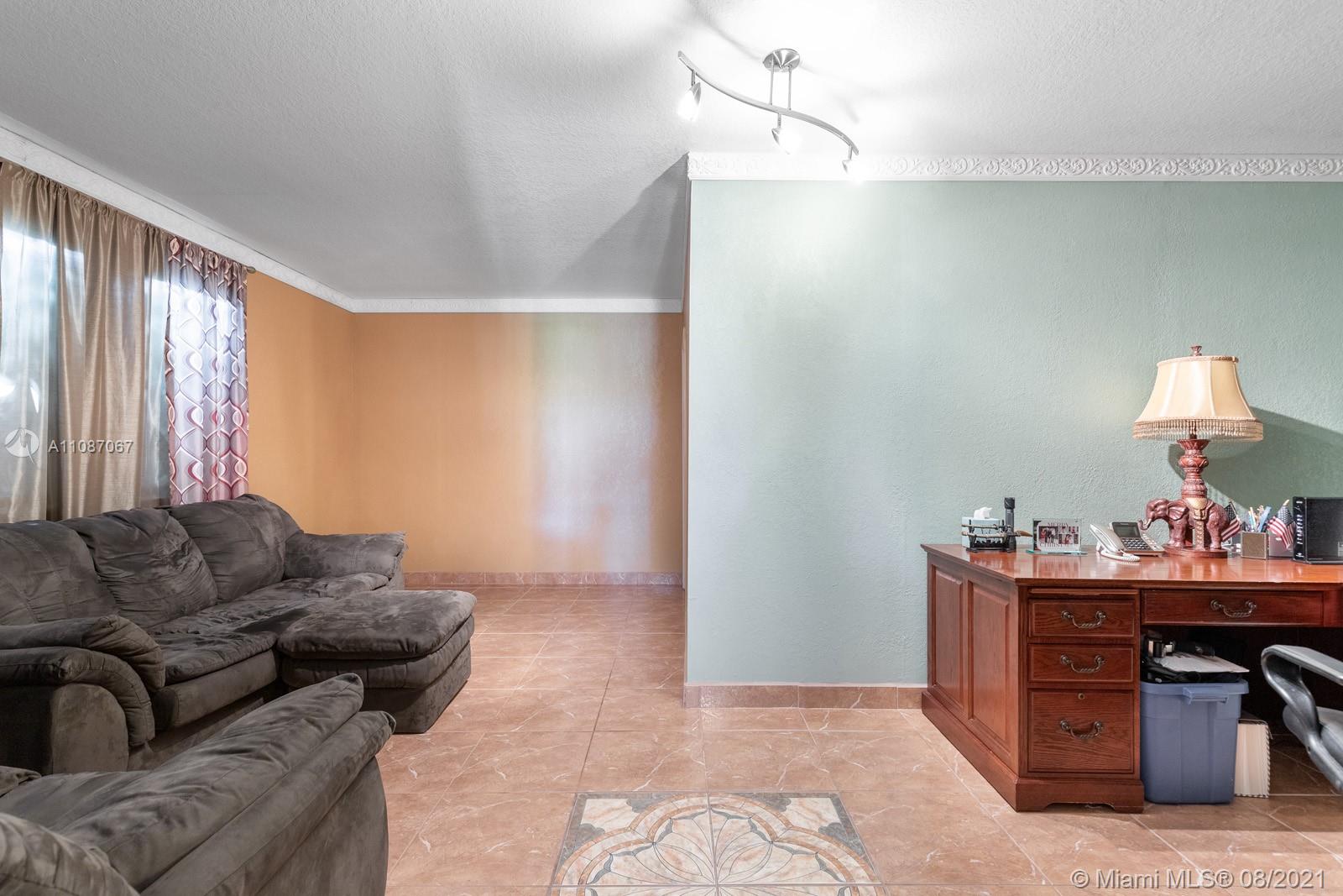 18017 Southwest 148th Ave Road Miami, FL 33187 - Photo 12 of 27 a living room with furniture and a window