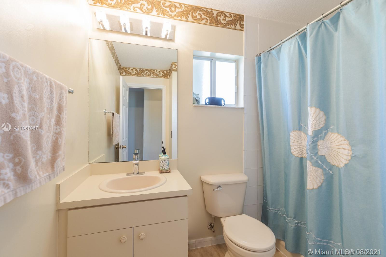 18017 Southwest 148th Ave Road Miami, FL 33187 - Photo 18 of 27 a bathroom with a sink a toilet and shower