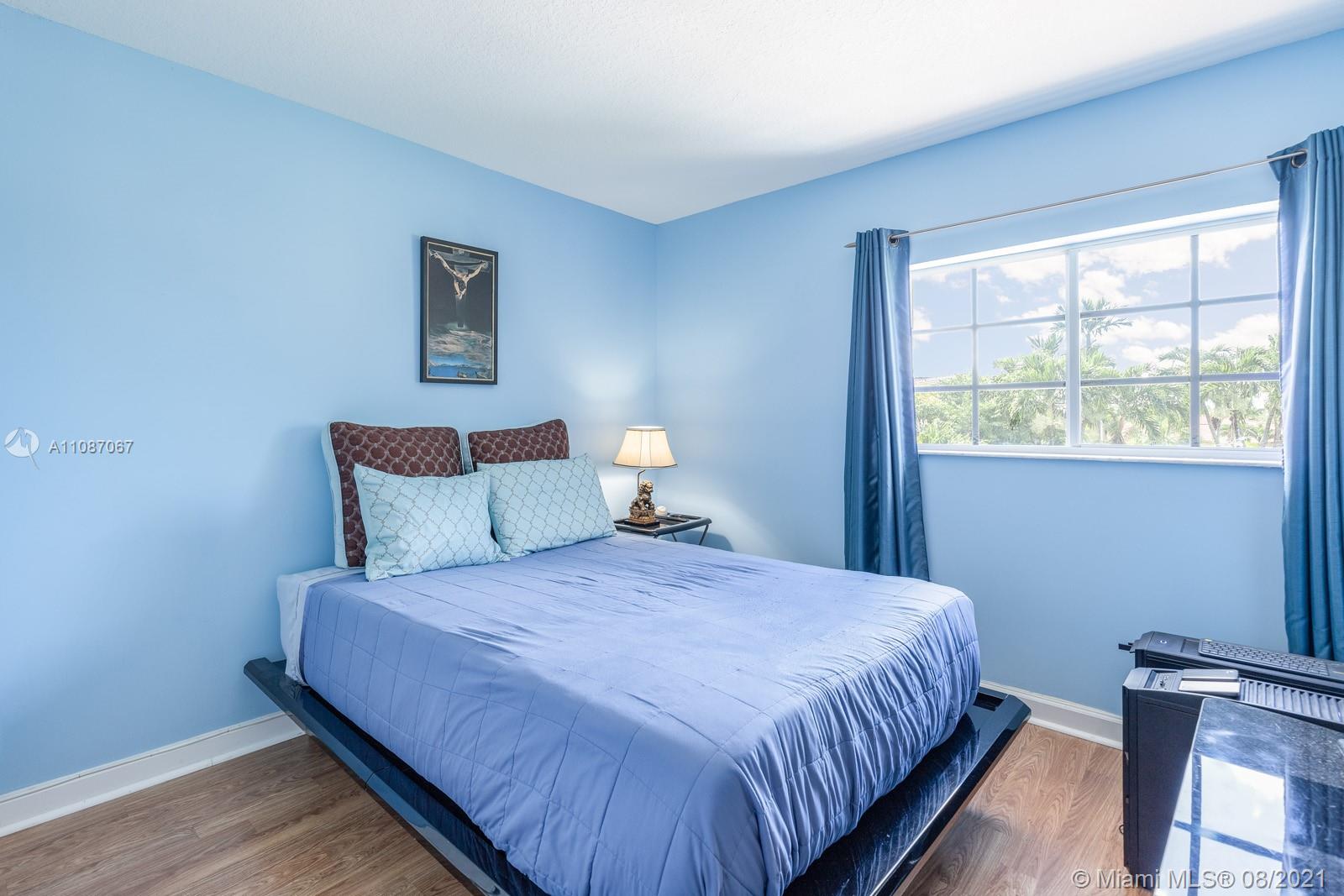 18017 Southwest 148th Ave Road Miami, FL 33187 - Photo 19 of 27 a bedroom with a bed and a window