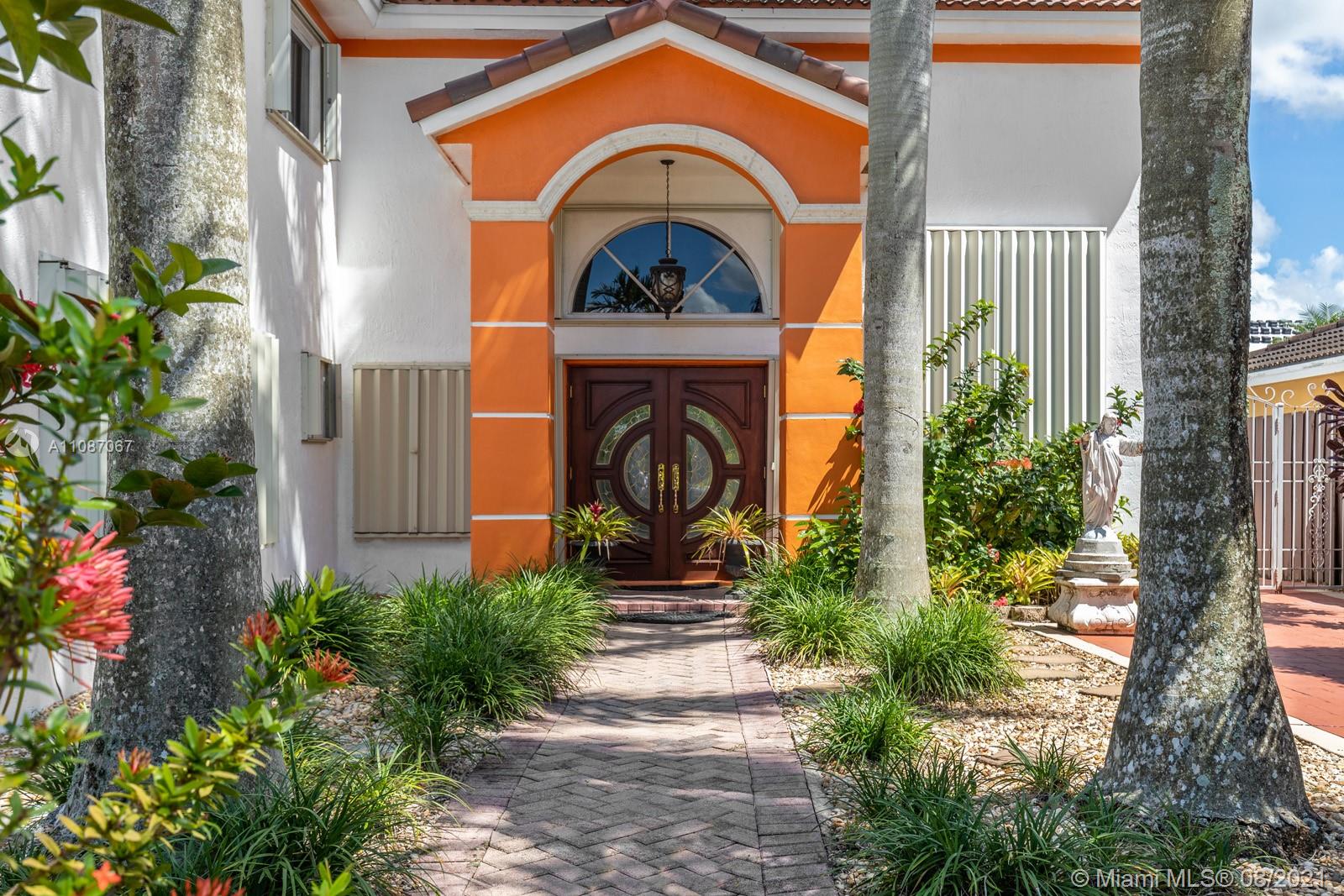 18017 Southwest 148th Ave Road Miami, FL 33187 - Photo 3 of 27 a front view of a house with plants