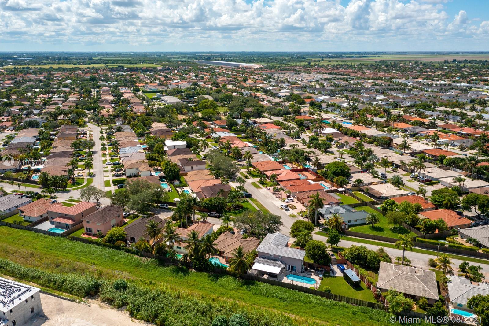 18017 Southwest 148th Ave Road Miami, FL 33187 - Photo 26 of 27 an aerial view of residential houses with outdoor space and trees