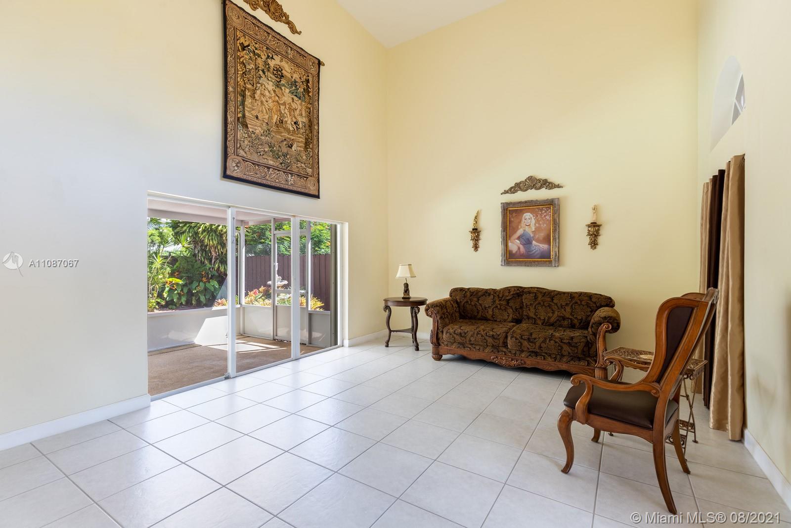 18017 Southwest 148th Ave Road Miami, FL 33187 - Photo 4 of 27 a living room with furniture and a large window