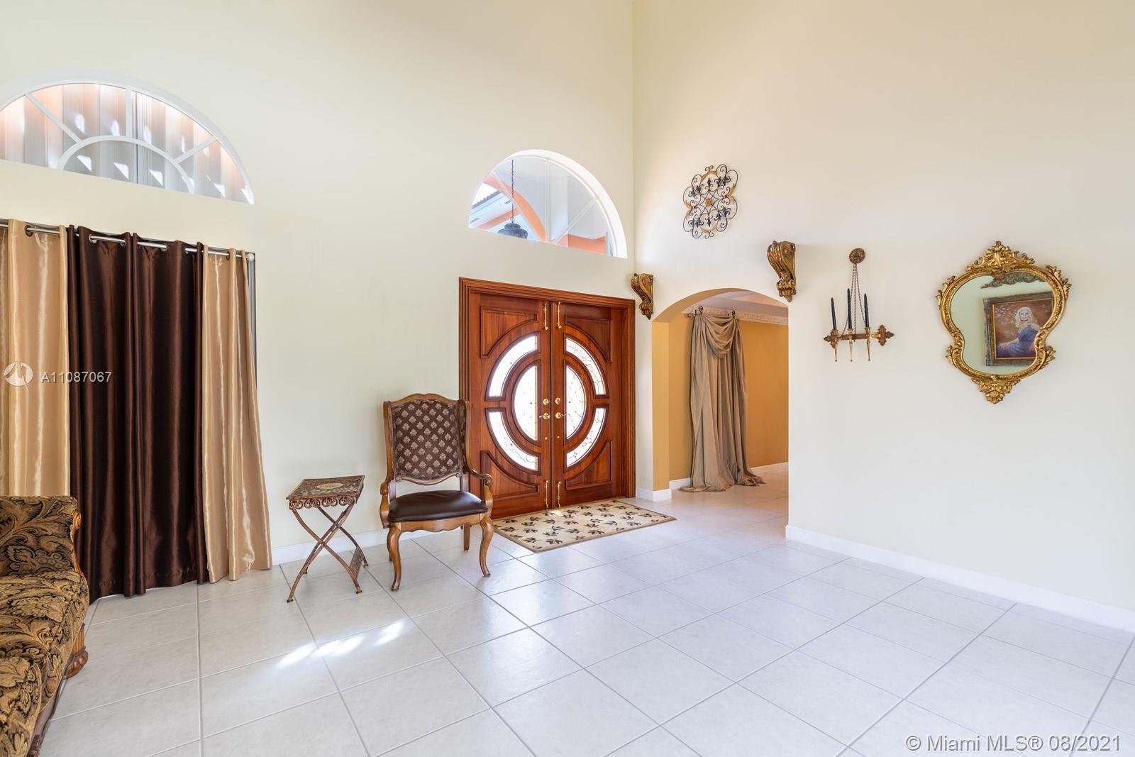 18017 Southwest 148th Ave Road Miami, FL 33187 - Photo 5 of 27 a view of a hallway with entryway wooden floor and cabinet