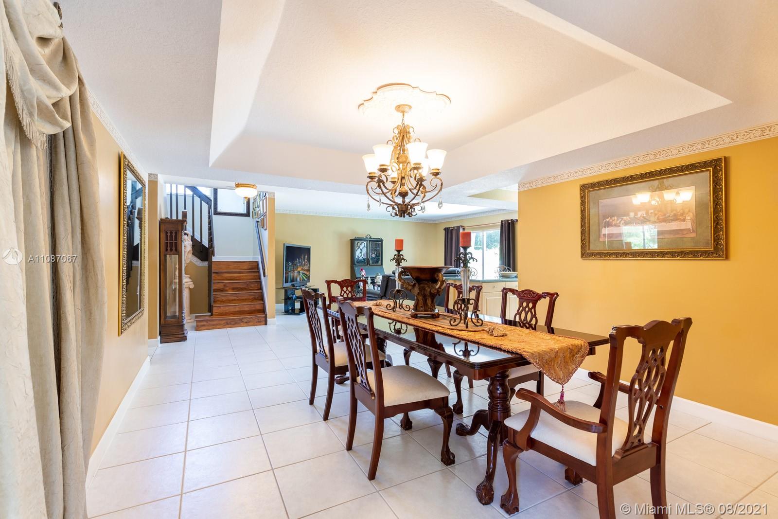 18017 Southwest 148th Ave Road Miami, FL 33187 - Photo 6 of 27 a view of a dining room with furniture and chandelier