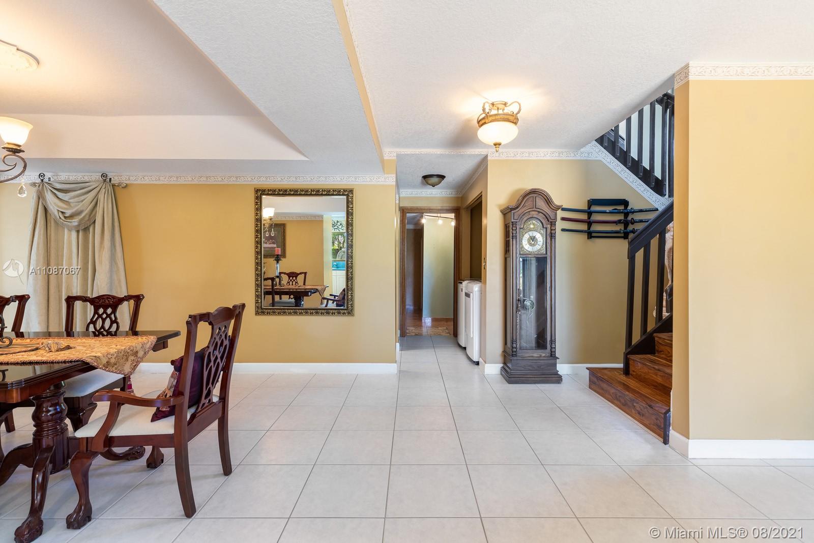 18017 Southwest 148th Ave Road Miami, FL 33187 - Photo 10 of 27 a dining room with furniture and a chandelier