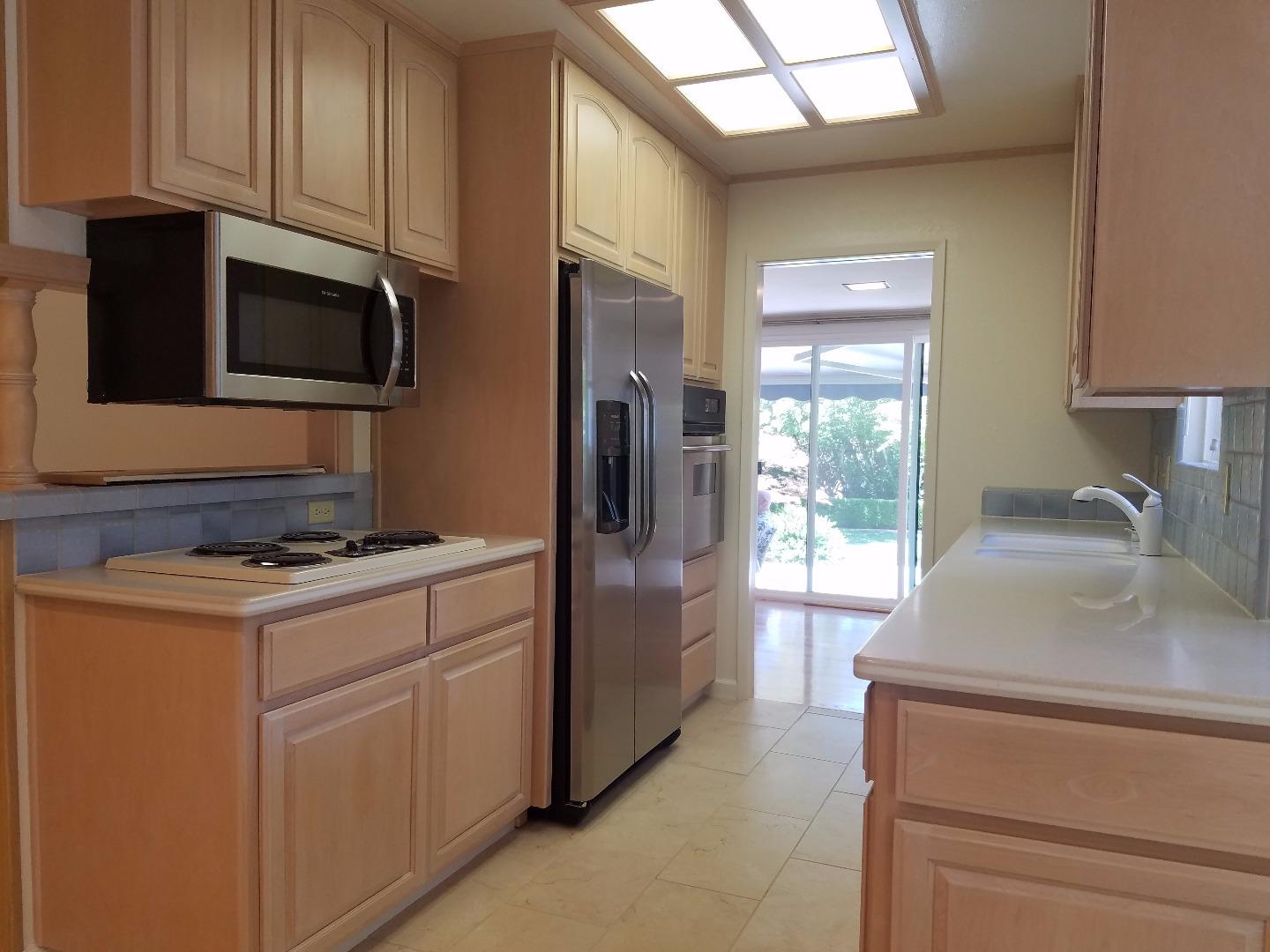 1451 Lewiston Drive Sunnyvale, CA 94087 - Photo 12 of 15 a kitchen with stainless steel appliances granite countertop a refrigerator stove and sink