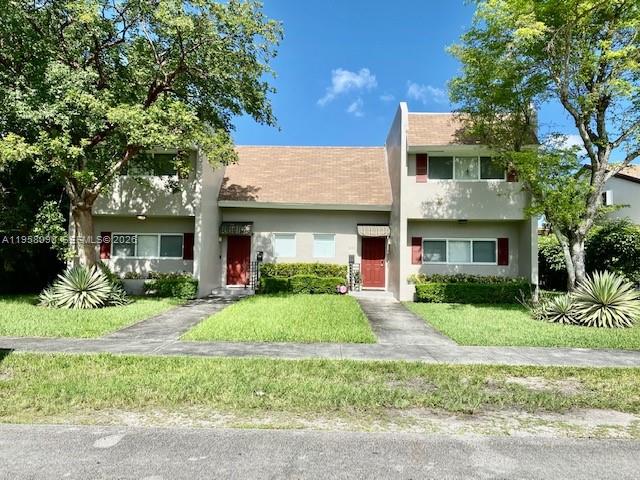 a front view of a house with a yard and porch