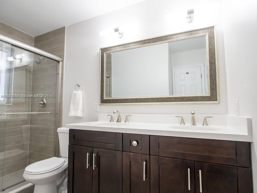 8940 Southwest 95th Avenue Miami, FL 33176 - Photo 12 of 21 a bathroom with a toilet sink double and mirror