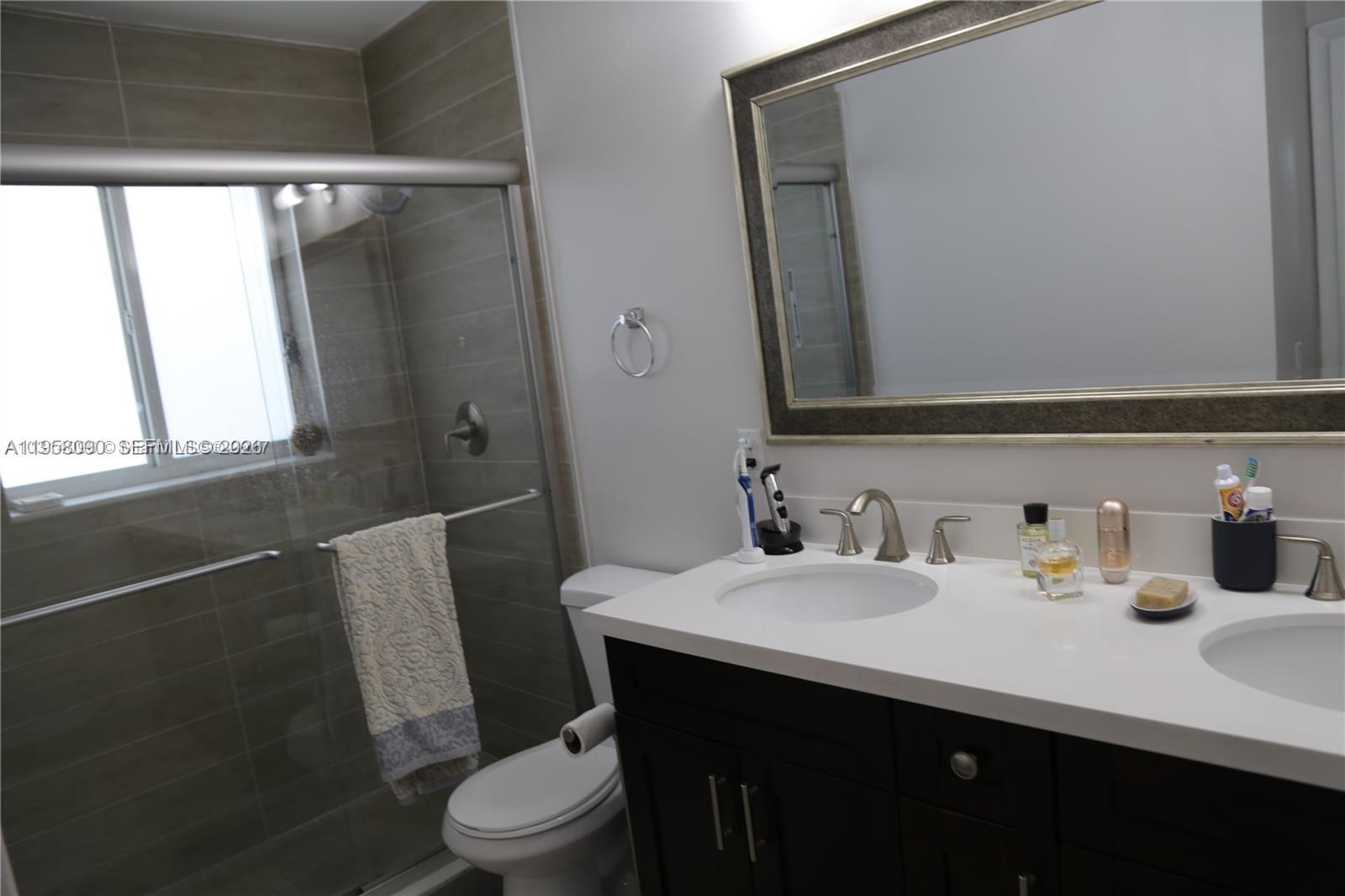 8940 Southwest 95th Avenue Miami, FL 33176 - Photo 13 of 21 a bathroom with a sink a toilet and mirror