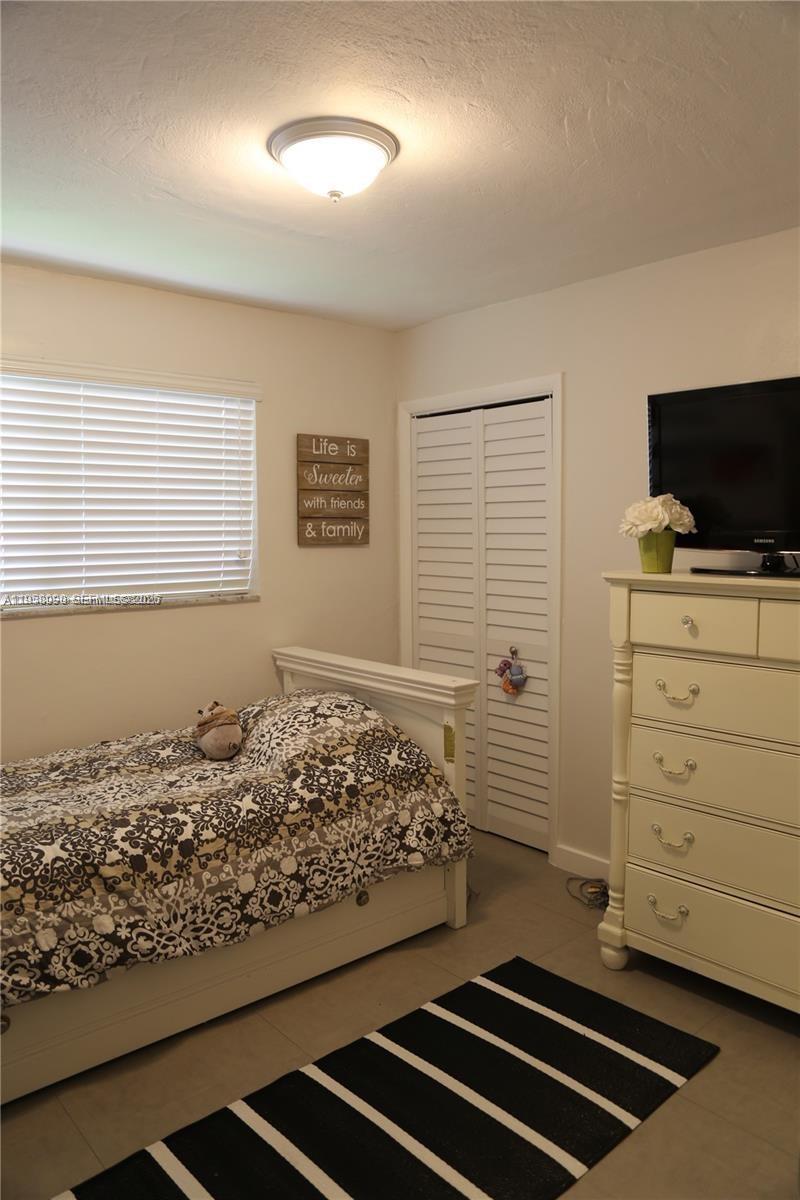 8940 Southwest 95th Avenue Miami, FL 33176 - Photo 16 of 21 a room with a bed and flat screen tv