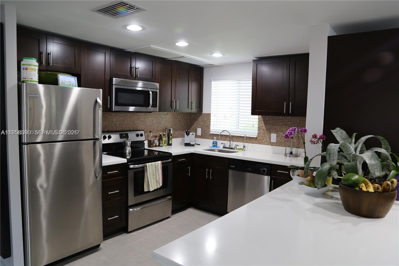 8940 Southwest 95th Avenue Miami, FL 33176 - Photo 5 of 21 a kitchen with stainless steel appliances kitchen island granite countertop a refrigerator and a sink