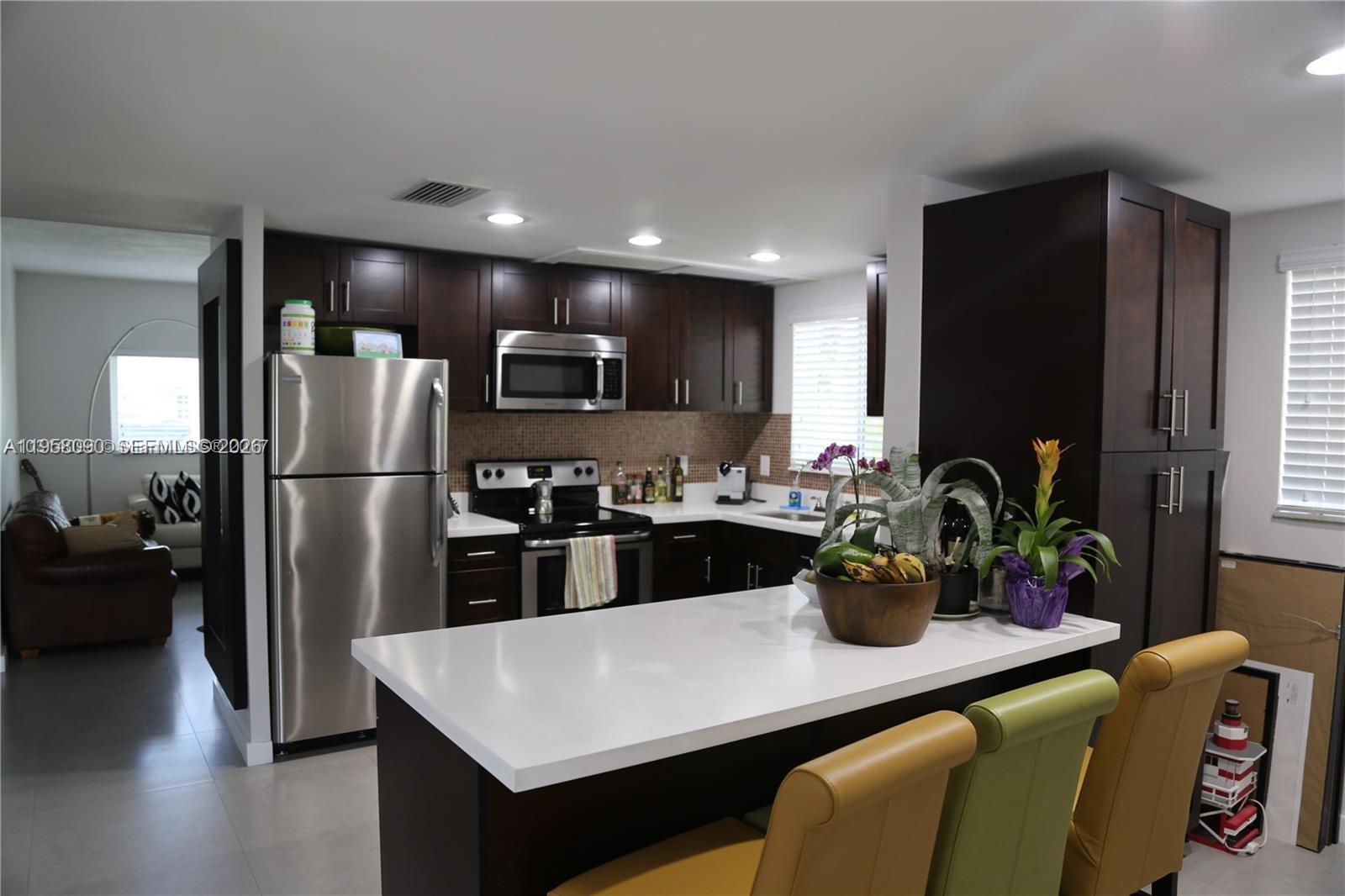 8940 Southwest 95th Avenue Miami, FL 33176 - Photo 6 of 21 a kitchen with a refrigerator and a sink
