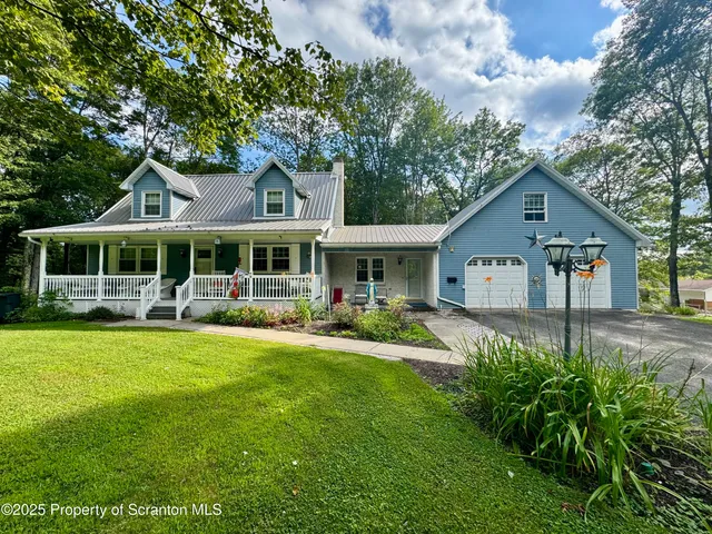 a front view of a house with swimming pool having outdoor seating
