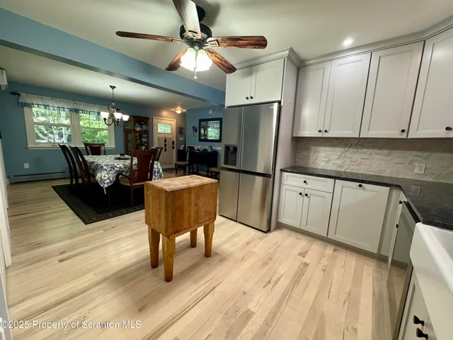 a living room with furniture a flat screen tv and a table