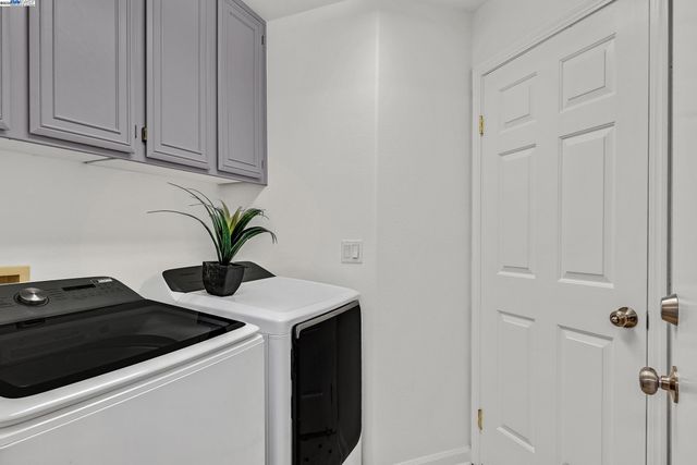 a close view of a sink and dishwasher in a white cabinet
