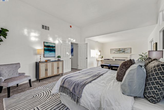 a bedroom with furniture a bed and a view of kitchen