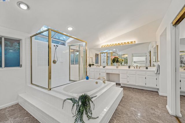 a spacious bedroom with a bed and a view of bathroom