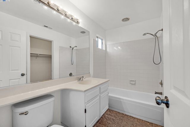 a bathroom with a tub sink double vanity and shower
