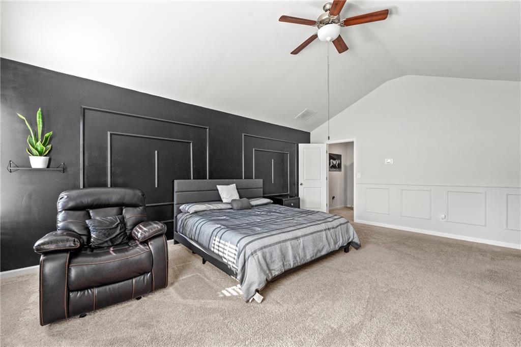 7492 Knoll Hollow Road Lithonia, GA 30058 - Photo 16 of 30 a spacious bedroom with a bed and window
