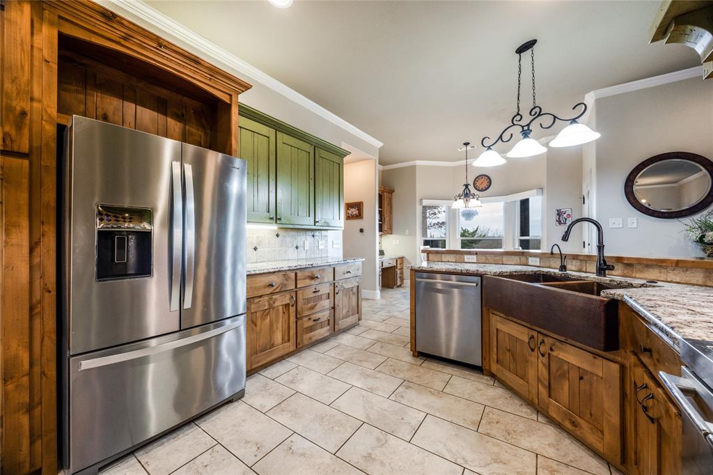 1462 Durham Road Whitewright, TX 75491 - Photo 11 of 40 a kitchen with stainless steel appliances granite countertop a sink a stove a refrigerator and a refrigerator