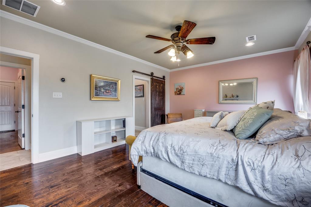 1462 Durham Road Whitewright, TX 75491 - Photo 15 of 40 a bedroom with a large bed and a chandelier