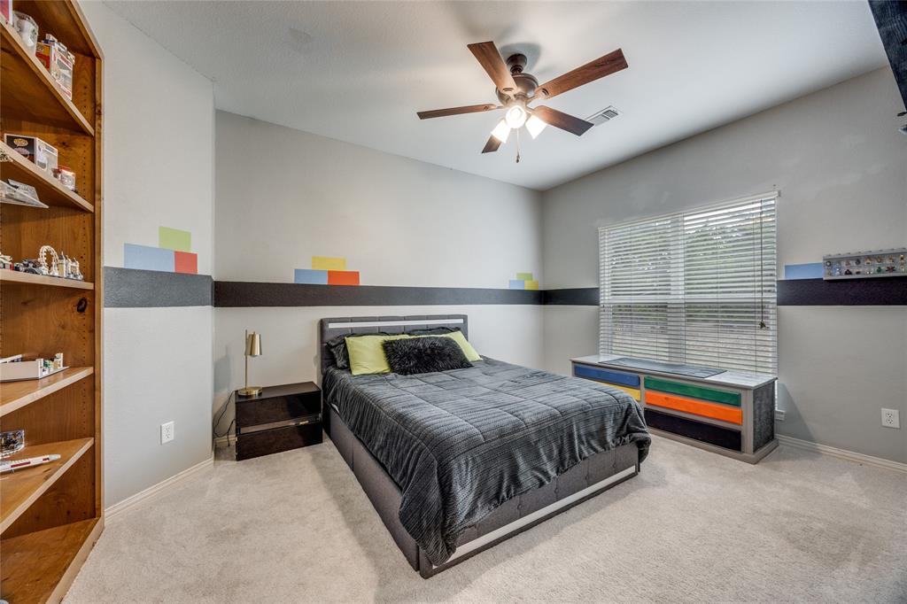 1462 Durham Road Whitewright, TX 75491 - Photo 22 of 40 a bedroom with a bed and a chandelier