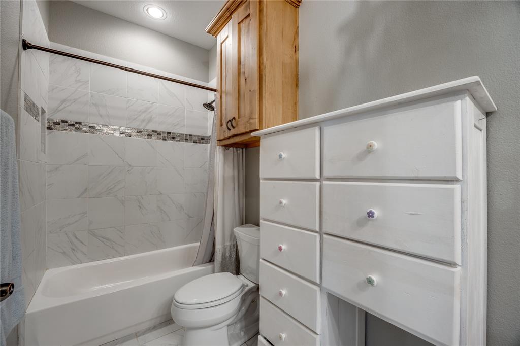 1462 Durham Road Whitewright, TX 75491 - Photo 25 of 40 a bathroom with a shower a toilet and sink