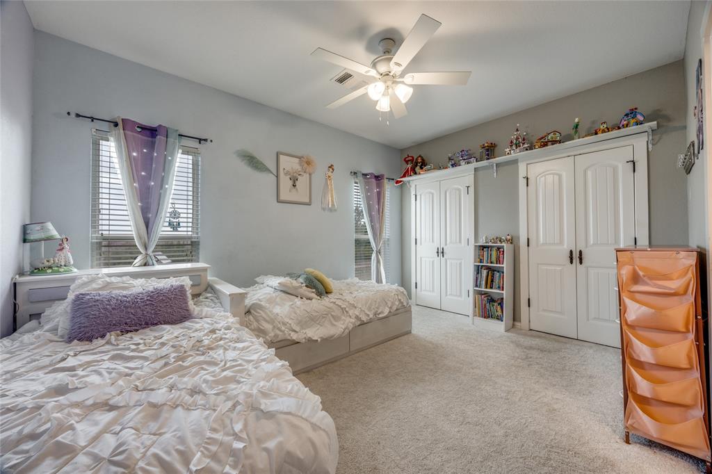 1462 Durham Road Whitewright, TX 75491 - Photo 27 of 40 a bedroom with a bed and a chandelier