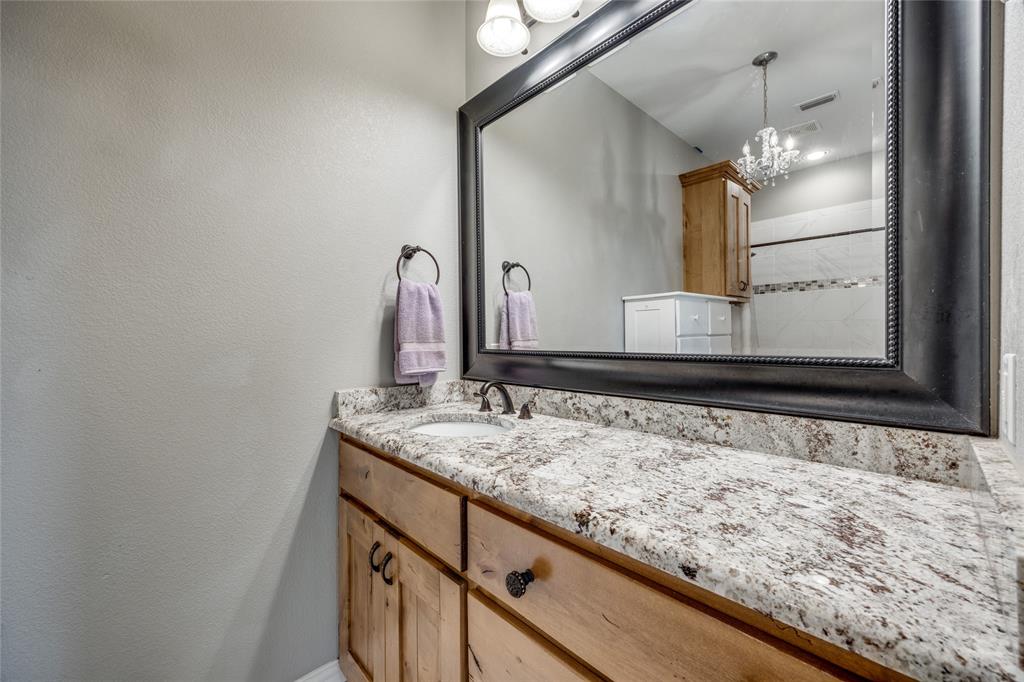 1462 Durham Road Whitewright, TX 75491 - Photo 29 of 40 a bathroom with a granite countertop sink and a mirror