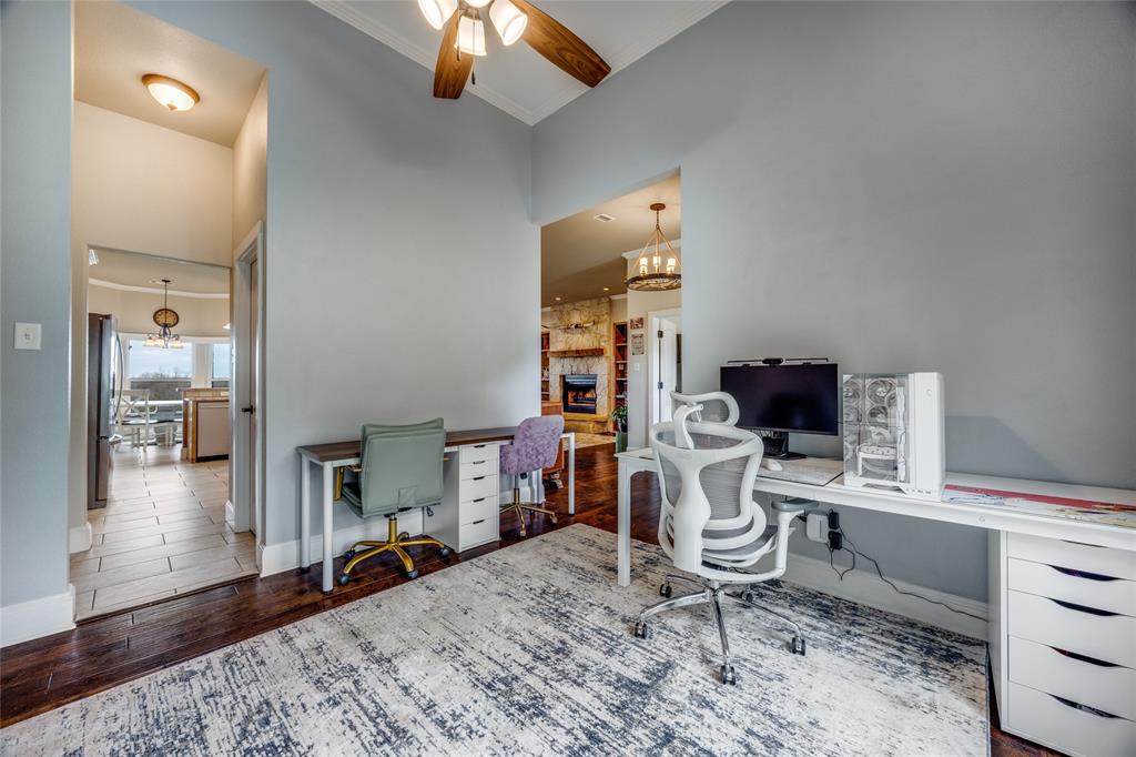 1462 Durham Road Whitewright, TX 75491 - Photo 5 of 40 a work room with furniture a rug and a chandelier