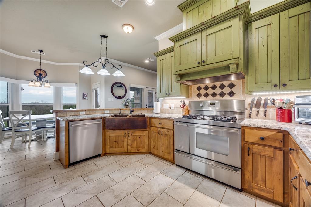 1462 Durham Road Whitewright, TX 75491 - Photo 10 of 40 a kitchen with kitchen island granite countertop lots of white stainless steel appliances and cabinets