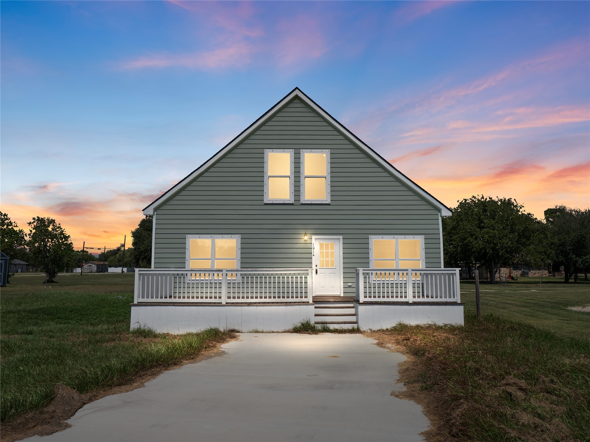a view of backyard of house with green space