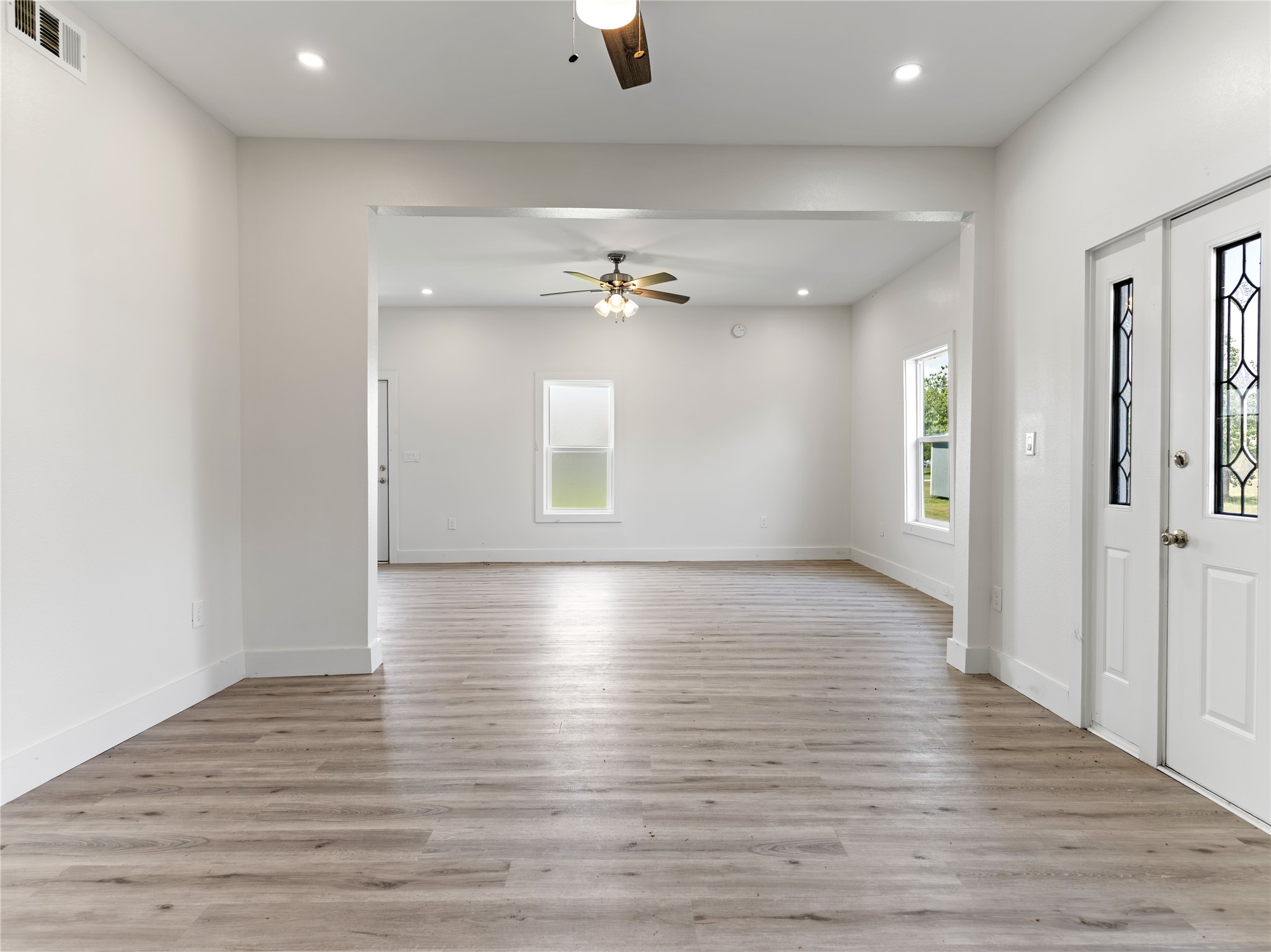 1014 Humphrey Street Palacios, TX 77465 - Photo 19 of 26 wooden floor in an empty room with a ceiling fan