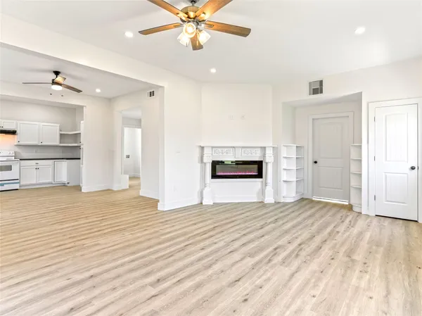 a kitchen with stainless steel appliances kitchen island a refrigerator sink and cabinets