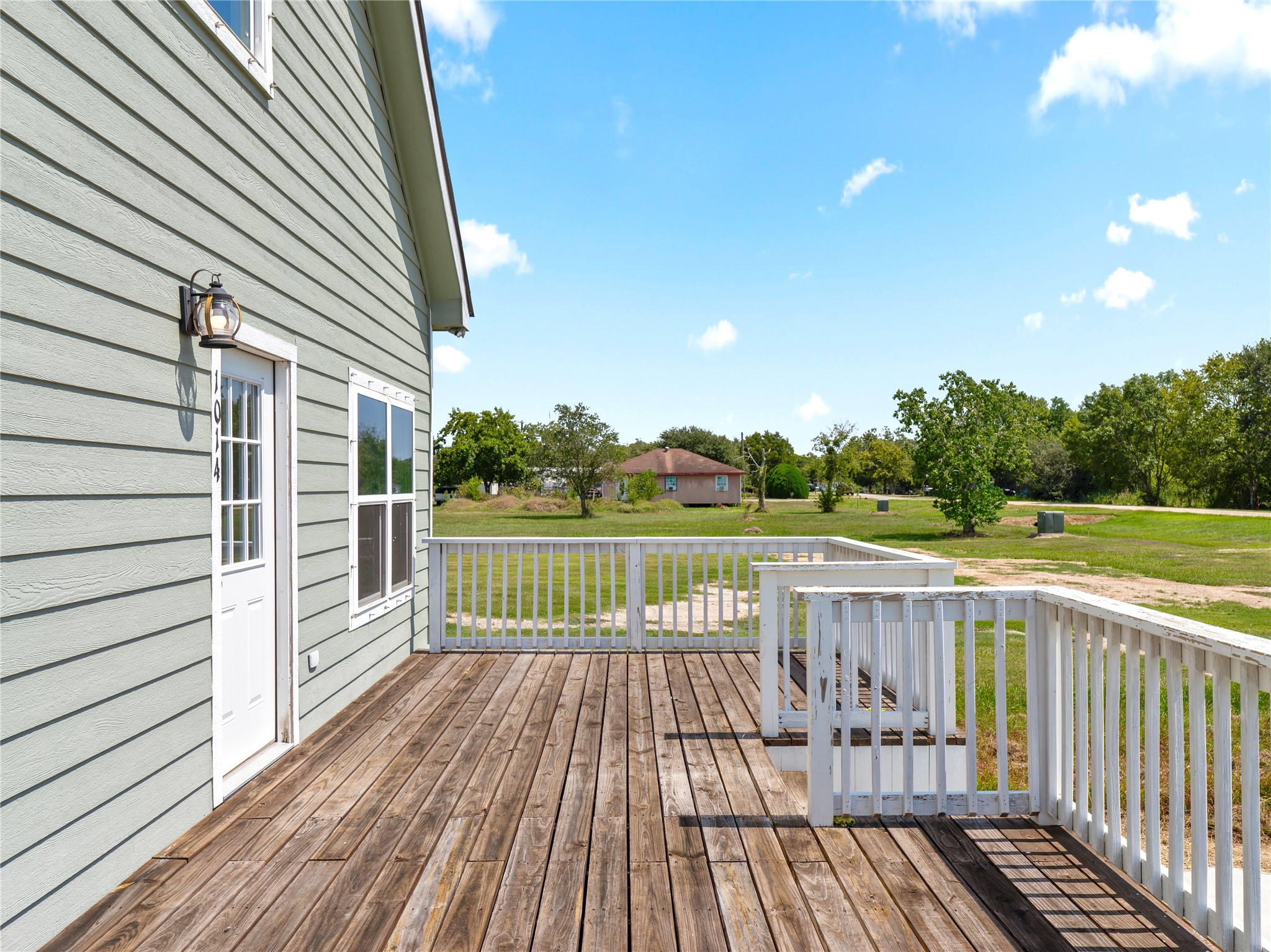 1014 Humphrey Street Palacios, TX 77465 - Photo 2 of 26 a view of balcony with wooden floor and fence