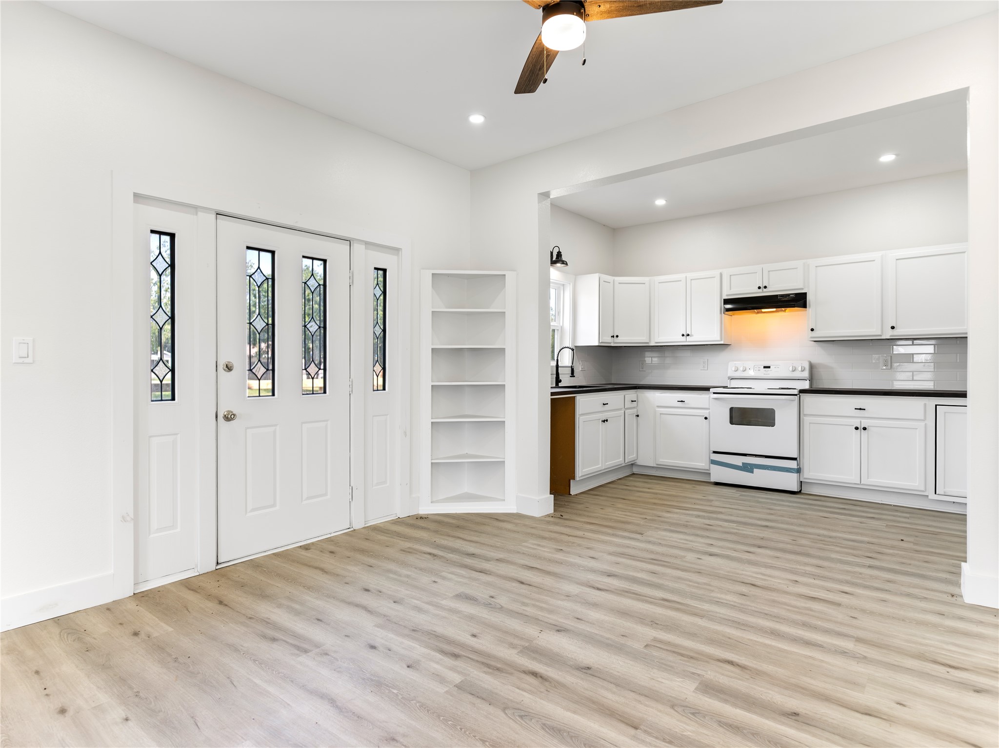 1014 Humphrey Street Palacios, TX 77465 - Photo 21 of 26 a kitchen with stainless steel appliances kitchen island a refrigerator sink and cabinets