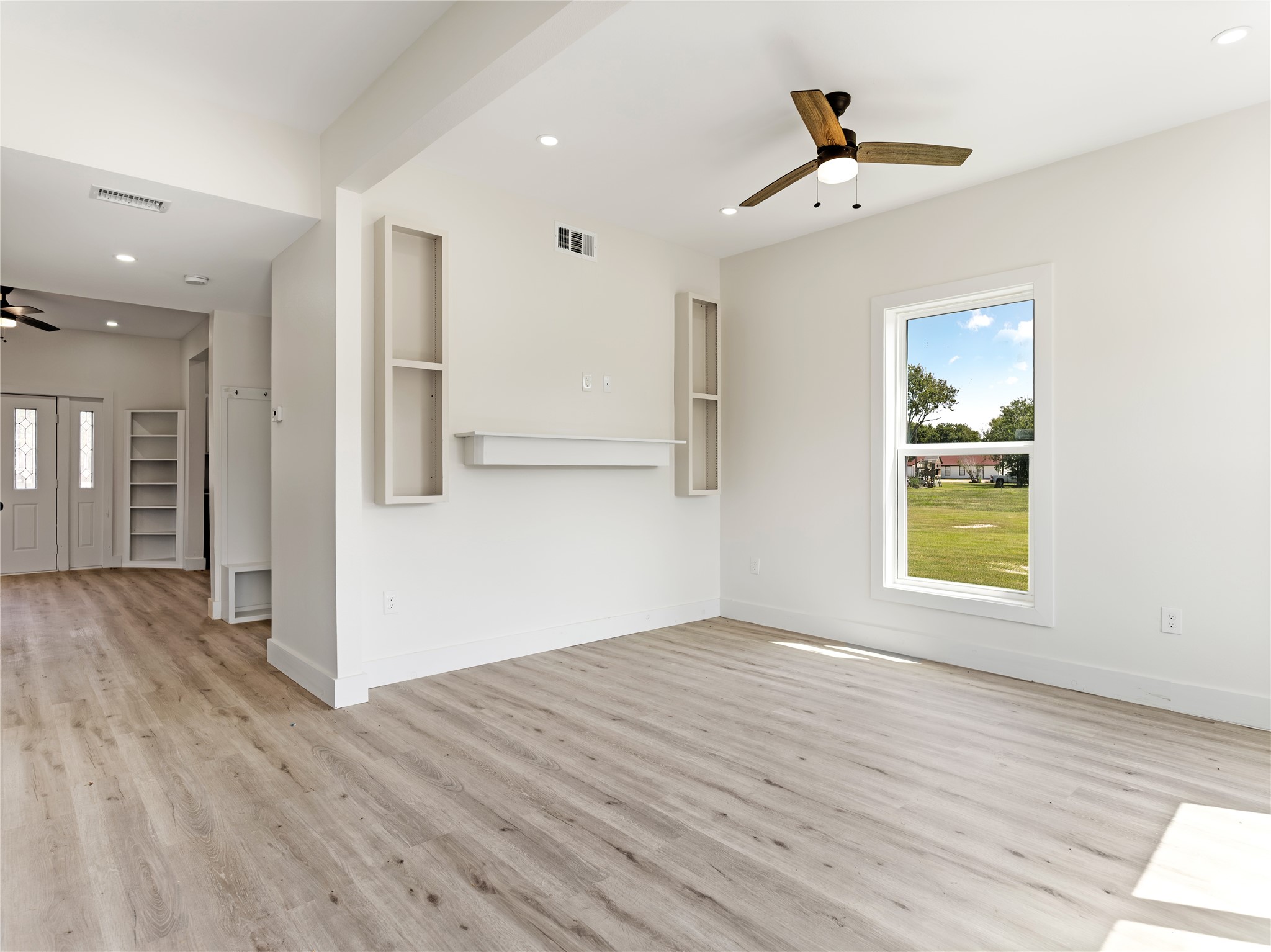 1014 Humphrey Street Palacios, TX 77465 - Photo 24 of 26 a view of an empty room with wooden floor and a window