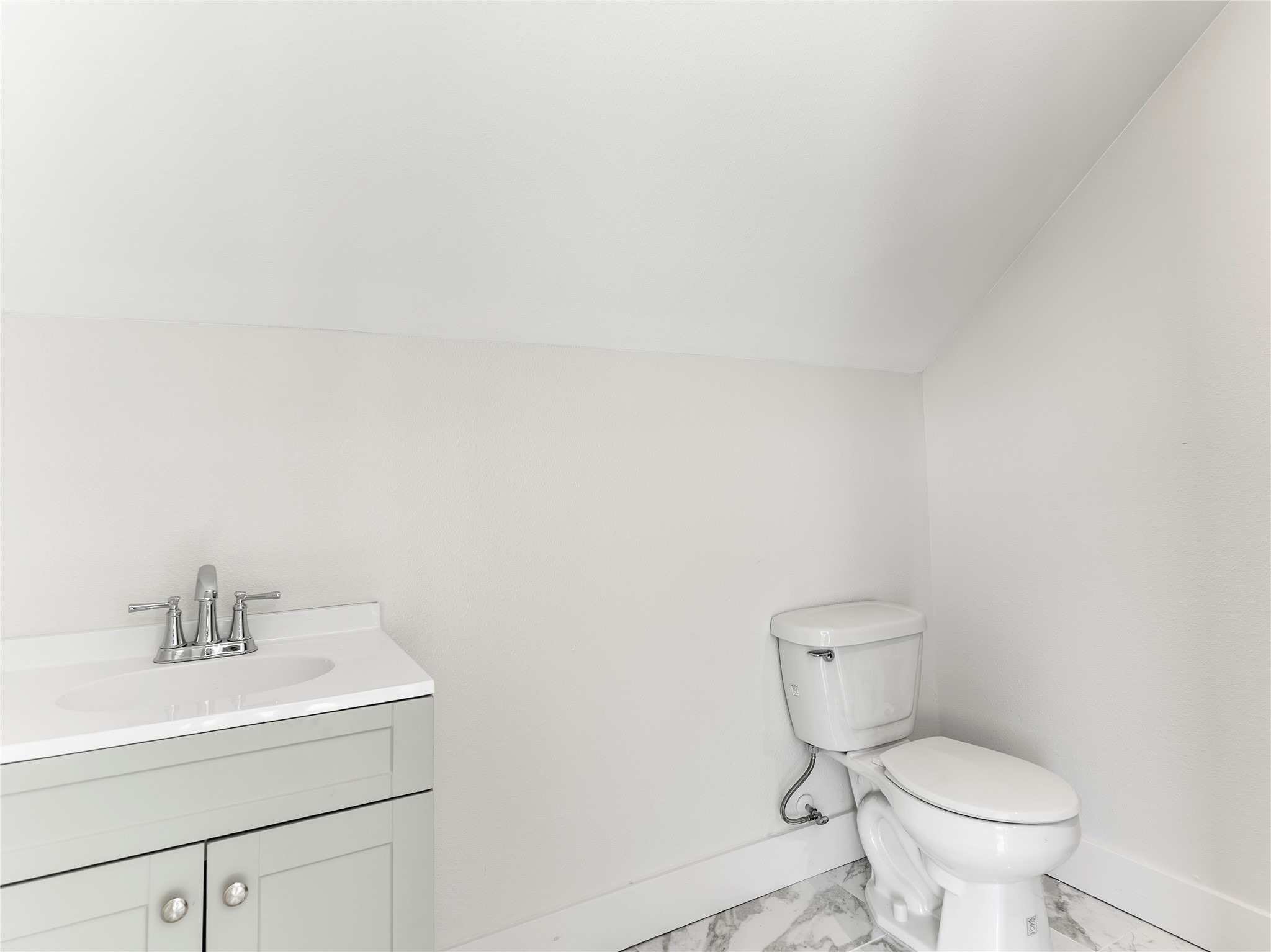 1014 Humphrey Street Palacios, TX 77465 - Photo 10 of 26 a bathroom with a toilet sink and mirror