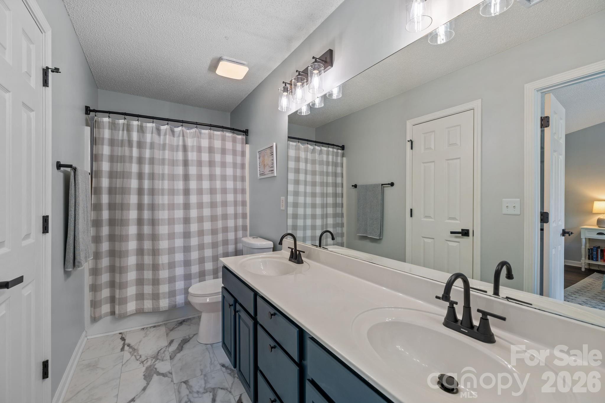 213 Butler Place Fort Mill, SC 29715 - Photo 17 of 36 a bathroom with a sink a toilet and shower